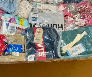 Wholesale Quince Clothing Apparel Liquidation Pallets stacked in Indiana warehouse