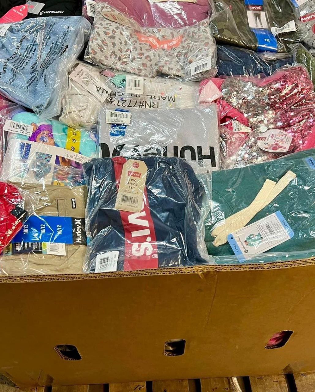 Wholesale Quince Clothing Apparel Liquidation Pallets stacked in Indiana warehouse